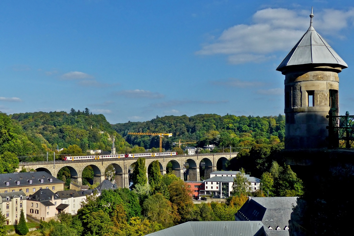 . Herbstbeginn in der Stadt Luxemburg - Der Versuch einen berrest der Festung Luxemburg mit ins Bild zu nehmen, als die Doppeleinheit Z 2000 als RB 3440 Ettelbrck - Luxembourg den Pfaffentaler Viadukt befhrt. 23.09.2014 (Jeanny)

Bei dem Festungsberrest, der leider teilweise schon im Schatten lag, handelt es sich um ein sogenanntes Spanisches Trmchen. Die Spanischen Trmchen in Luxemburg entstanden Mitte des 17. Jahrhunderts als Teil der groen Befestigung, die von den Spaniern begonnen und unter Vauban fortgesetzt wurde. Der eigentliche Zweck der Trmchen ist bis heute nicht einwandfrei geklrt. Es soll bis zu 38 solcher Trmchen gegeben haben, davon sind heute noch acht erhalten.