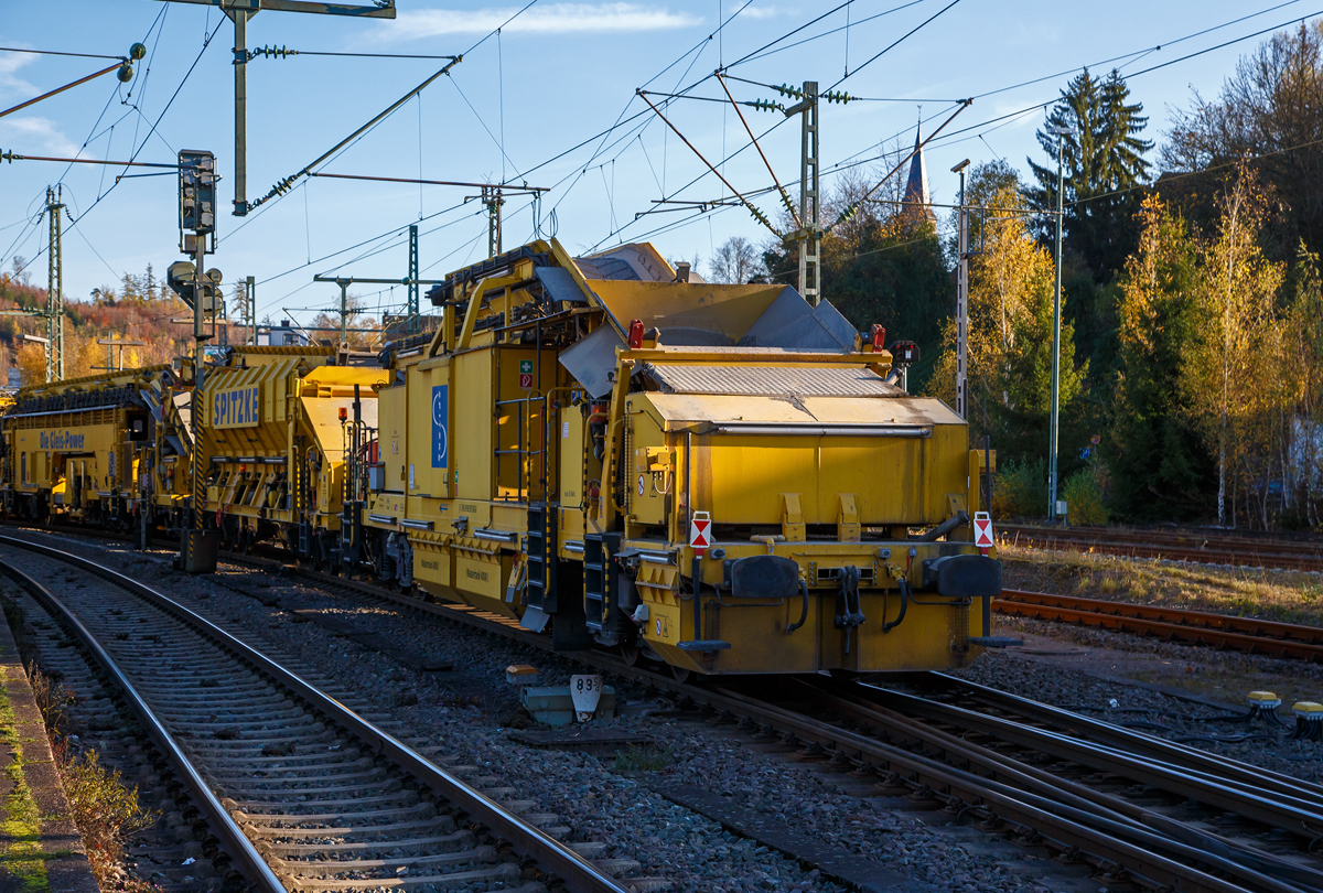 Die Plasser & Theurer Planumssanierungs- und Reinigungsmaschine RPM-RS-900 „Katharina die Große“ der SPITZKE SE (Großbeeren), Schweres Nebenfahrzeug Nr. D-SPAG 99 80 9415 004 – 1 (ex 97 19 35 501 18-1), am 09.11.2021 bei einer Zugdurchfahrt in Betzdorf (Sieg) in Richtung Siegen.

Hier als Detailbild (am Zugschluss) der Übergabewagen mit Kehrbürste für Schotter (RPM-RS 900 UEW), 99 80 9515 002-0 D-SPAG (ex 97 19 35 901 58-9), P&T Fabriknummer 4800.
