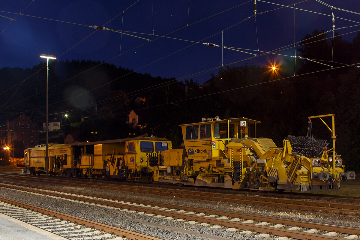 
Die Plasser und Theurer Universalstopfmaschine 08-475 Unimat 4S (Schweres Nebenfahrzeug Nr. 99 80 9424 005-3 D-KG, ex 97 43 42 522 17-0) und dahinter die Plasser und Theurer Schnellschotterplaniermaschine SSP 110 SW (Schweres Nebenfahrzeug Nr. 99 80 9425 026-8 D-KG), beide der Kölngleis, abgestellt in Dillenburg, aufgenommen nachts (23:32Uhr) des 01.07.2015. 

Die SPITZKE AG hat ein 60-prozentige Beteiligung an der KÖLNGLEIS Gleisbau GmbH & Co. KG.