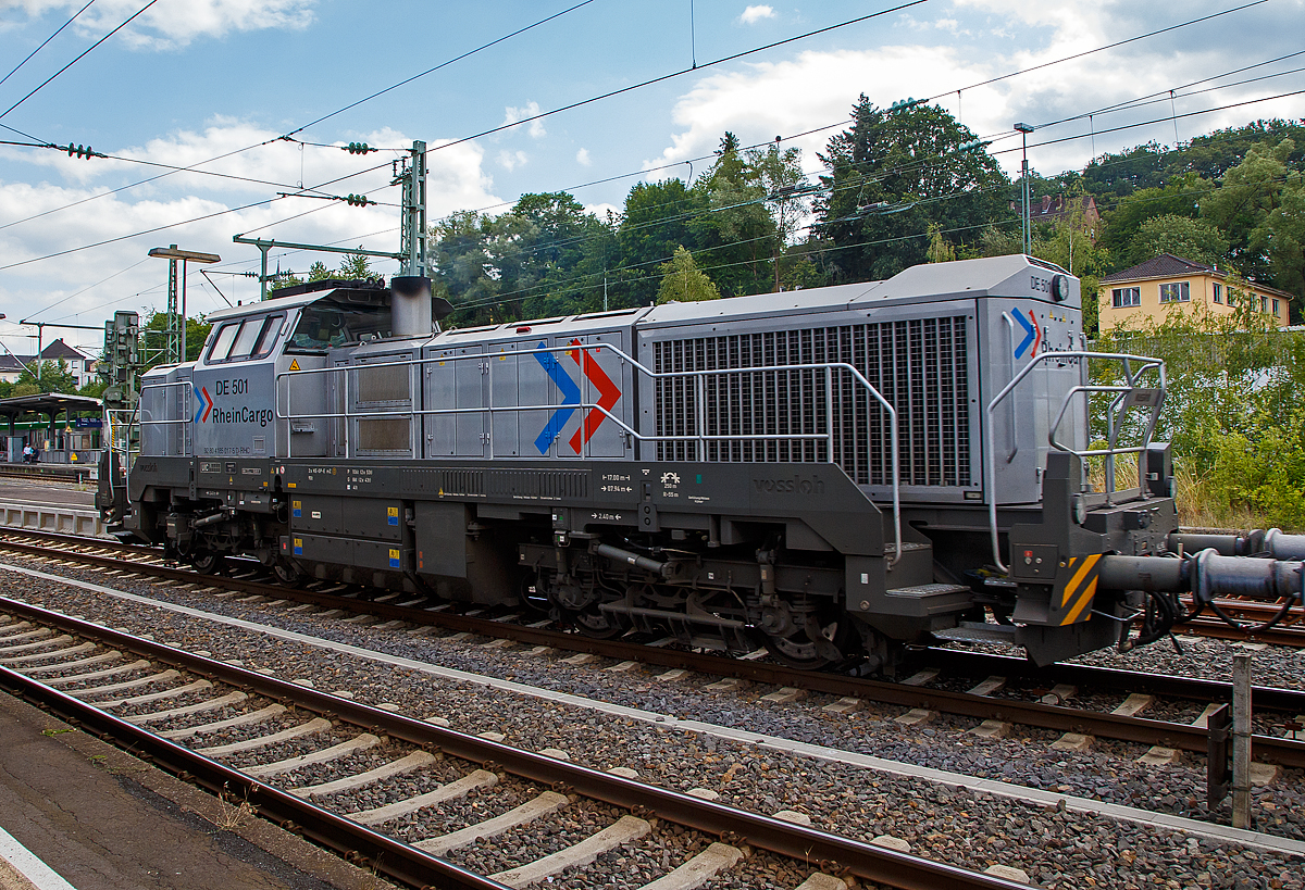 Die RHC DE 501 alias 4185 017-5 (92 80 4185 017-5 D-RHC), eine Vossloh DE 18, der RheinCargo f�hrt am Sonntag den 07.07.2019 mit einem Kalkzug (4-achsige Trichtermittenentladewagen der Gattung Tadns) durch Betzdorf/Sieg in Richtung Siegen.

Die dieselelektrische DE 18 wurde 2017 von Vossloh unter der Fabriknummer 5502235 gebaut.

Die Vossloh DE 18 ist eine diesel-elektrisch angetriebene Lokomotive f�r den schweren Rangier- und Streckendienst mit der Achsfolge Bo'Bo'. Es handelt sich um die erste Lokomotive aus dem ehemaligen MaK-Werk Kiel seit der Einstellung der Produktion der DE 1002 im Jahr 1993. Etwa 60 % der Bauteile der DE 18 sind mit denjenigen der diesel-hydraulischen Variante G 18 deckungsgleich. Die Konstruktion des Fahrzeuges entspricht nach Herstellerangaben der Crash-Norm EN 15227. Einsatzbereit mit mehreren europ�ischen L�nderzulassungen nach TSI hat sich die vierachsige Universallokomotive als hochmoderner Branchenstandard etabliert. Bei Geschwindigkeiten zwischen 17 und 120 km/h bietet die DE 18 kontinuierlich eine Leistung von 1.800 kW, was sie zur aktuell leistungsst�rksten Mittelf�hrerhauslokomotive auf dem europ�ischen Markt macht.

TECHNISCHE DATEN:
Spurweite:  1.435 mm 
Achsfolge:  B‘B‘
L�nge �ber Puffer : 17.000 mm  
Drehzapfenabstand: 7.940 mm
Achsabstand im Drehgestell: 2.400 mm
Raddurchmesser:  1.000 mm (neu) / 920 mm (abgenutzt)
Gr��te H�he:  4.310 mm  
Gr��te Breite:  3.080 mm
H�chstgeschwindigkeit: 120 km/h
Dieselmotor Typ:  MTU 12V 4000 R43L 
Dieselmotorleistung:  1.800 kW (2.447 PS) bei 1.800 U/min
Leistungs�bertragung: elektrisch
Stromrichter : IGBT
Traktionsmotoren: 4 St�ck Drehstrom-Asynchronmotoren
Leistung am Rad: 1.440 kW
Anfahrzugkraft:  300 kN
Dauerzugkraft: 230 kN bei 24.2 km/h
Dienstgewicht:  90 t
Kraftstoffvorrat:  4.000 l
Elektrodynamische Bremsleistung: max. 1.450 kW  
Bremse: 2 x KE-GP-E mZ (D)
Kleinster befahrbarer Bogenradius:  55 m

Weitere Motordaten (MTU 12V 4000 R43L):
Dieselmotorart: 12 Zylinder -Viertakt-90�-V-Dieselmotor mit Abgasturboaufladung, Ladeluftk�hlung und Common-Rail-Einspritzung
Motorhersteller: Motoren- und Turbinen-Union Friedrichshafen (MTU)
Motorhubraum: 57.2 l (� 170 mm Bohrung x 210 mm Hub)
Motorabmessungen: 2.386 x 1.562 x 2.015 mm
Motorgewicht: 6.613 kg (trocken)
Abgasvorschriften:  EU/2004/26 Stufe IIIA/prepared for stage IIIB  
