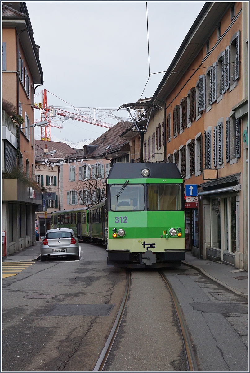 Immer wieder eindrücklich, die Ortsdurchfahrt der A-L in Aigle! 
Der BDeh 4/4 312 schiebt seine beiden Bt Richtung Aigle Bahnhof.
7. Jan. 2018