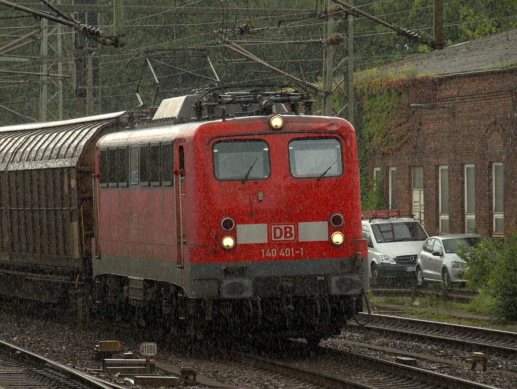 Inzwischen mit Zettel in Maschen abgestellt fährt hier die 140 401-1 bei einem kurzen aber heftigen Schauer durch HH-Harburg. 19.08.2011