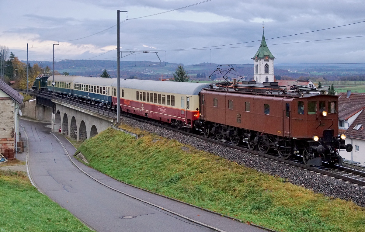 SBB/DB: DB/SBB HISTORIC: 
Rückführung der Ce 6/8 III 14305 von Meiningen bis Olten nach zwei Jahren.
Die Überfuhr  wurde vom 3. November bis 5. November 2017 durch das Team Lützel durchgeführt. Als Zugloks standen die 140 423 sowie die 218 460 vom DB Museum Koblenz im Einsatz. Als Begleitwagen für Eisenbahnfreunde wurden zwei Bm und der Clubwagen mitgeführt. Die 218 460 machte sich bereits kurz nach der Ankunft in Singen nach der Betankung als Lokzug auf die Rückfahrt. In Schaffhausen wurden die Ce 6/8 III 14305 und die Begleitwagen von der Be 4/7 12504 übernommen für die Weiterfahrt nach Olten.
Diese Aufnahme vom 5. November 2017 dokumentiert die Überfuhr bei Lottstetten am späten Nachmittag bei schlechten Lichtverhältnissen.
Foto: Walter Ruetsch  