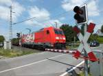 Im uersten Sden Hildens liegt dieser Bahnbergang, den die Jubilumslok 185 399 am 3.6.13 mit dem Mercedes-Sprinter-Zug aus Dsseldorf-Derendorf passiert.