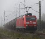 185 146-8 mit Kesselwagen nach Rostock-Seehafen bei der Durchfahrt in der Gterumgehung in Hhe Rostock Hbf.01.09.2012